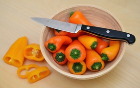 Bulgarian pepper in a bowl with a knife