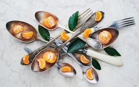 Cutlery on the table with mandarin slices