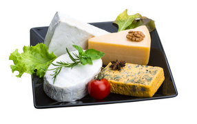 Different types of cheese on a black plate on a white background