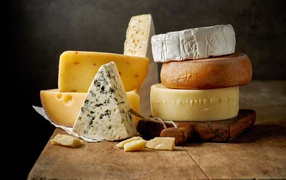 Different types of cheese on a wooden table