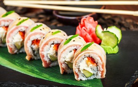 Rolls on a plate with ginger and wasabi sauce