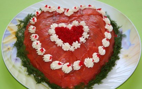 Salad with red fish in the shape of a heart