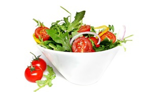 Salad with tomatoes and arugula on white background