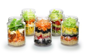 Salads in jars on a white background