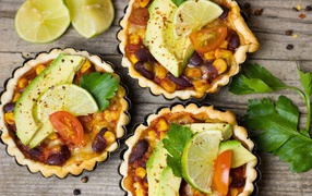 Tartlets with a dish of avocado and lime on the table