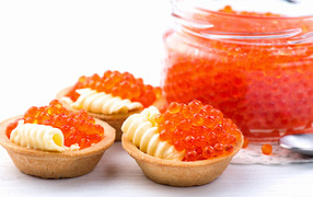 Tartlets with cheese and red caviar on the table
