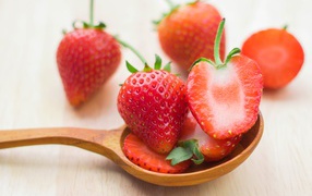 Fresh red strawberries on wooden spoon