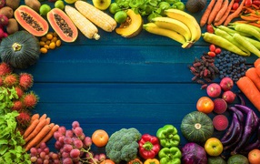 Fruits, berries and vegetables on a blue background