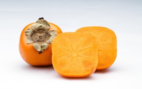 Orange persimmon on a gray background close-up