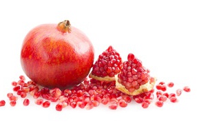Red pomegranate with grains on a white background