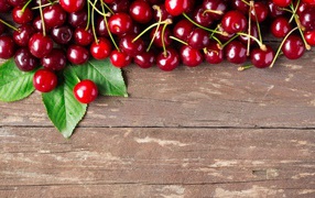 Red ripe cherries on a wooden table