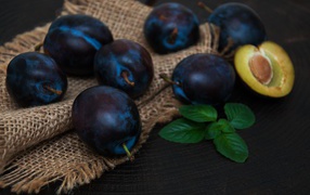 Ripe blue plums on the table
