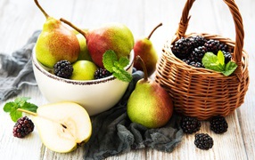 Ripe pears and blackberries on a table