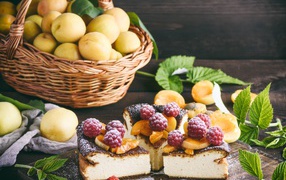 Delicious fruit and berry pie on a table with a basket of apricots