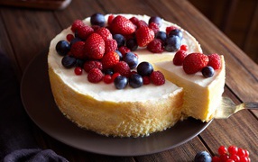 Appetizing cheesecake with berries of red currant, raspberry, strawberry and blueberry