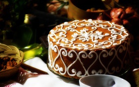 Красивый торт с белым рисунком  на столе