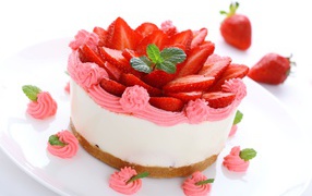 Delicious cake souffle with pink cream and strawberry