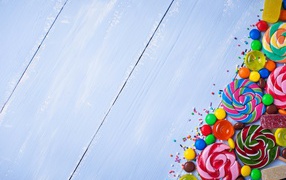 Разноцветные конфеты на голубом столе