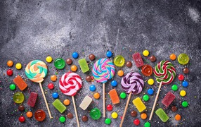Multi-colored lollipops on a gray table
