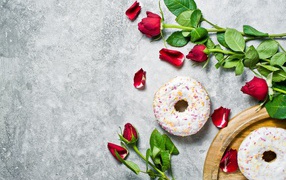 Red roses on a gray background with donuts