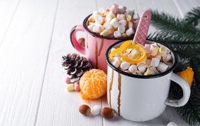 Two iron mugs with marshmallows on the table