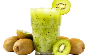 A glass of kiwi drink on a white background with kiwi fruit