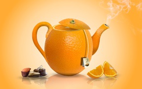 Orange teapot on orange background with candies
