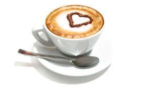 White cappuccino cup with cinnamon heart on foam