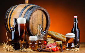 Wooden barrel on the table with beer and snacks