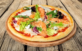 Appetizing pizza with fish and arugula