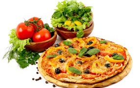 Pizza on the table with vegetables and herbs on white background