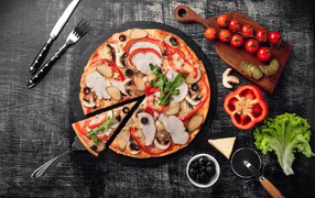 Pizza with pepper, meat and mushrooms on the table