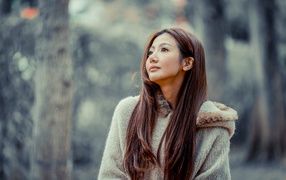 Asian long-haired girl looks away