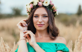Beautiful blue-eyed girl with a wreath on his head