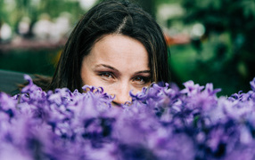 Beautiful brown-eyed brunette with hyacinth flowers