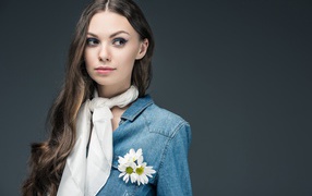 Красивая девушка в джинсовой куртке с шарфом на шее 