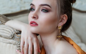 Beautiful girl with long eyelashes with beautiful earrings