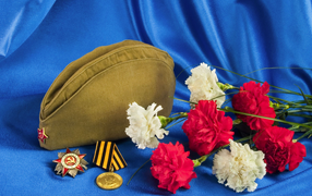 Bouquet of carnations, field cap, Order of the Patriotic War, and a medal on a blue background