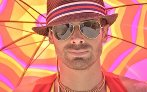 Мужчина в солнечных очках и шляпе летом