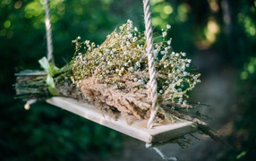 Букет полевых цветов на лежат на качели