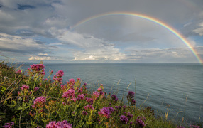 Rainbow over the sea in the sky with clouds