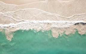 Warm white sea waves on the sand