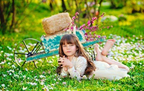 Little girl lying on green grass