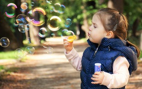 Little girl with soap bubbles