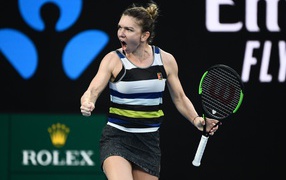 Romanian tennis player Simone Halep with a racket screams on the court