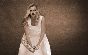 Tennis player Petra Kvitova in a white dress with a racket