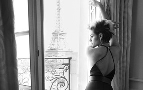 Actress Kristen Stewart stands at the window in Paris