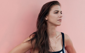 American football player Alex Morgan on a pink background