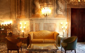 Antique room interior with a sofa and armchairs