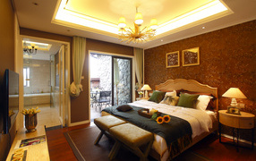 Красивая спальня с большой кроватью и телевизором 